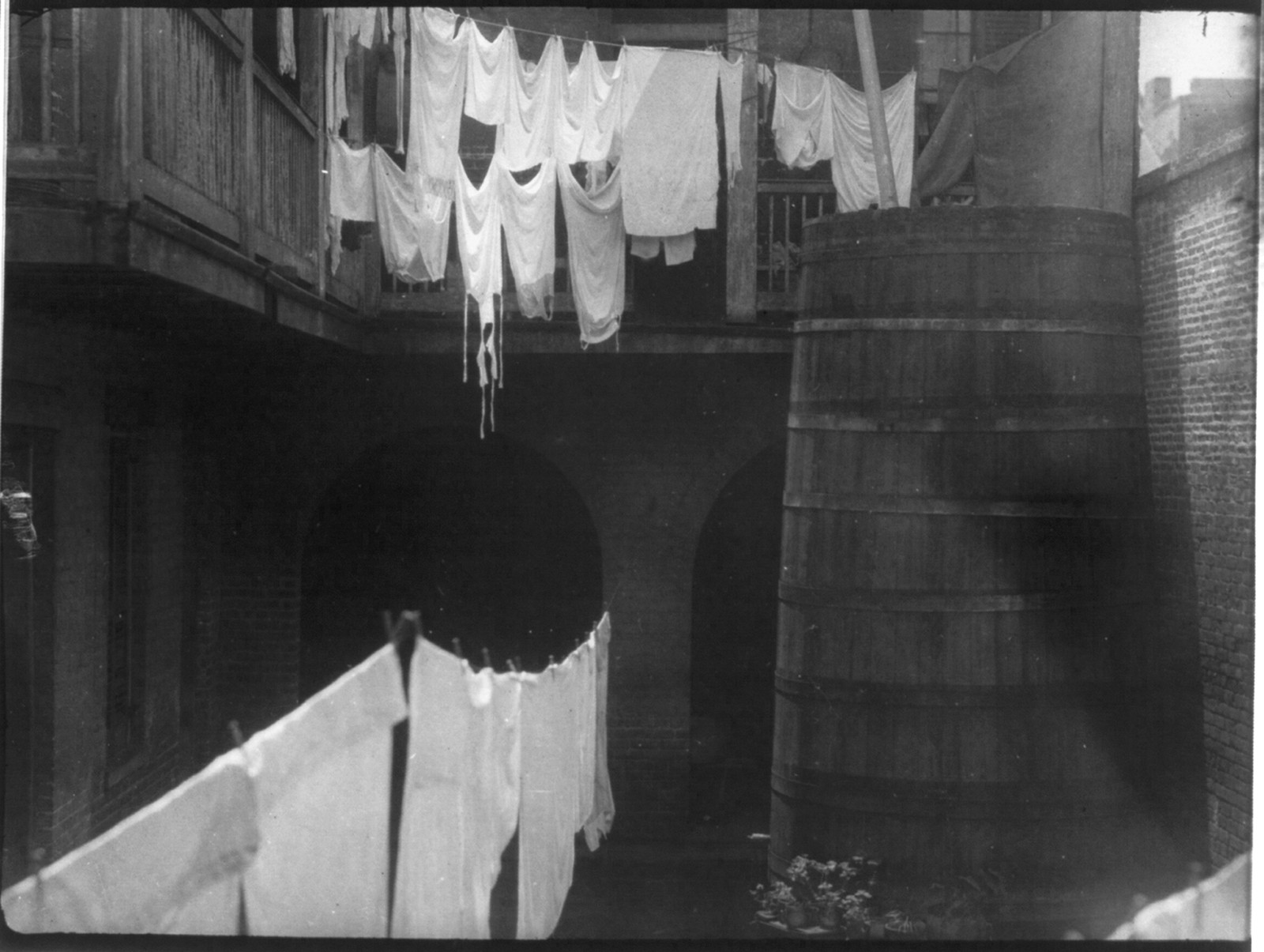 [Clotheslines in New Orleans courtyard, ca. 1925] — historic photograph
