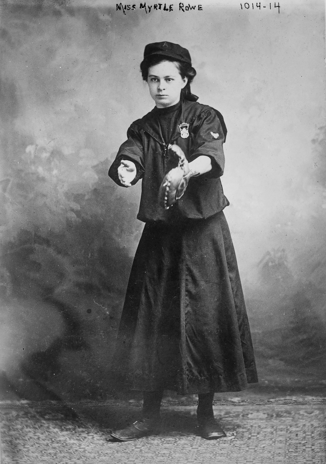 Miss Myrtle Rowe holding a baseball mitt, 3/14/10. — historic photograph