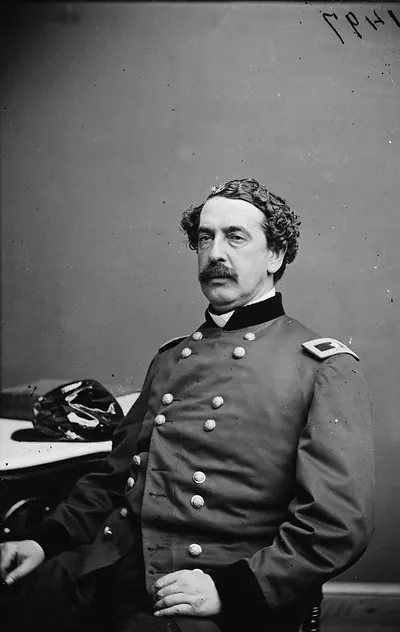 Seated Civil War officer in double-breasted uniform, studio portrait