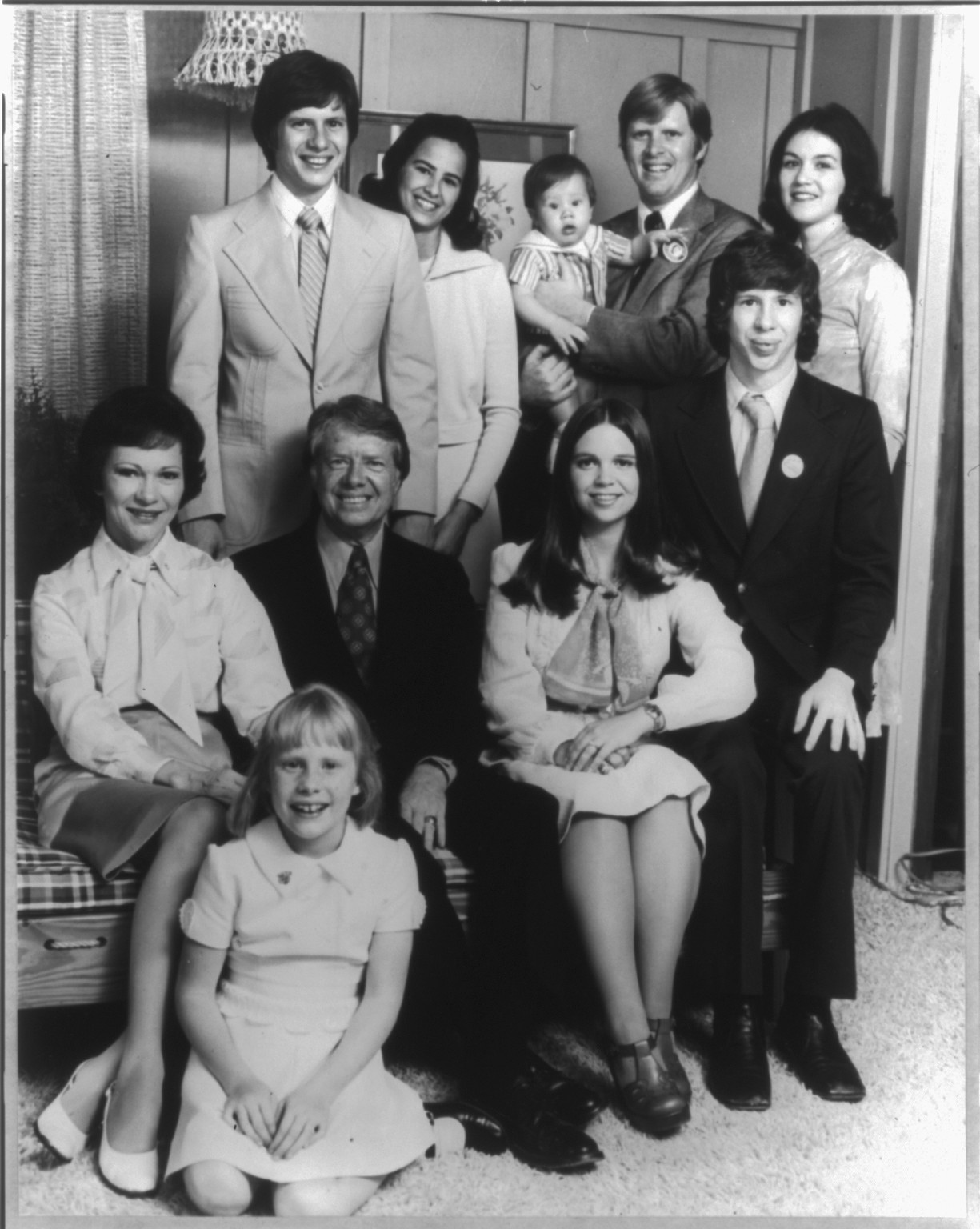 [Jimmy Carter, full-length portrait, seated, facing front, with nine members of his family], [1976] — historic photograph