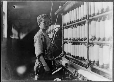 [John Dempsey (looked 11 or 12) years old. Said he helped only on Saturdays. Jackson Mill, Fiskeville, R. I. (One of the B. B. and R. Knight mills). He was working faithfully in the mule-spinning room, a dangerous place for boys. I found no others below 14 in this mill,]. Location: Fiskeville, Rhode Island.