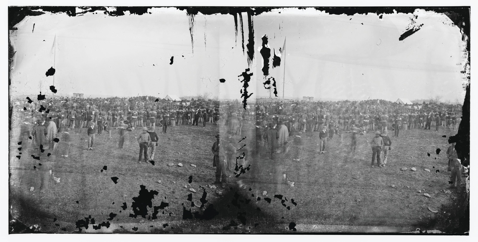 Large crowd gathered on an open field — historic image
