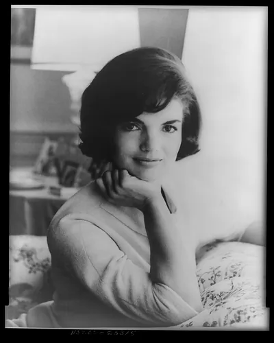 [First official White House photograph of Mrs. John F. Kennedy, half-length portrait, seated on couch, facing front]