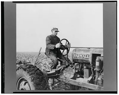 Tip Estes operating a tractor. Near Fowler, Indiana