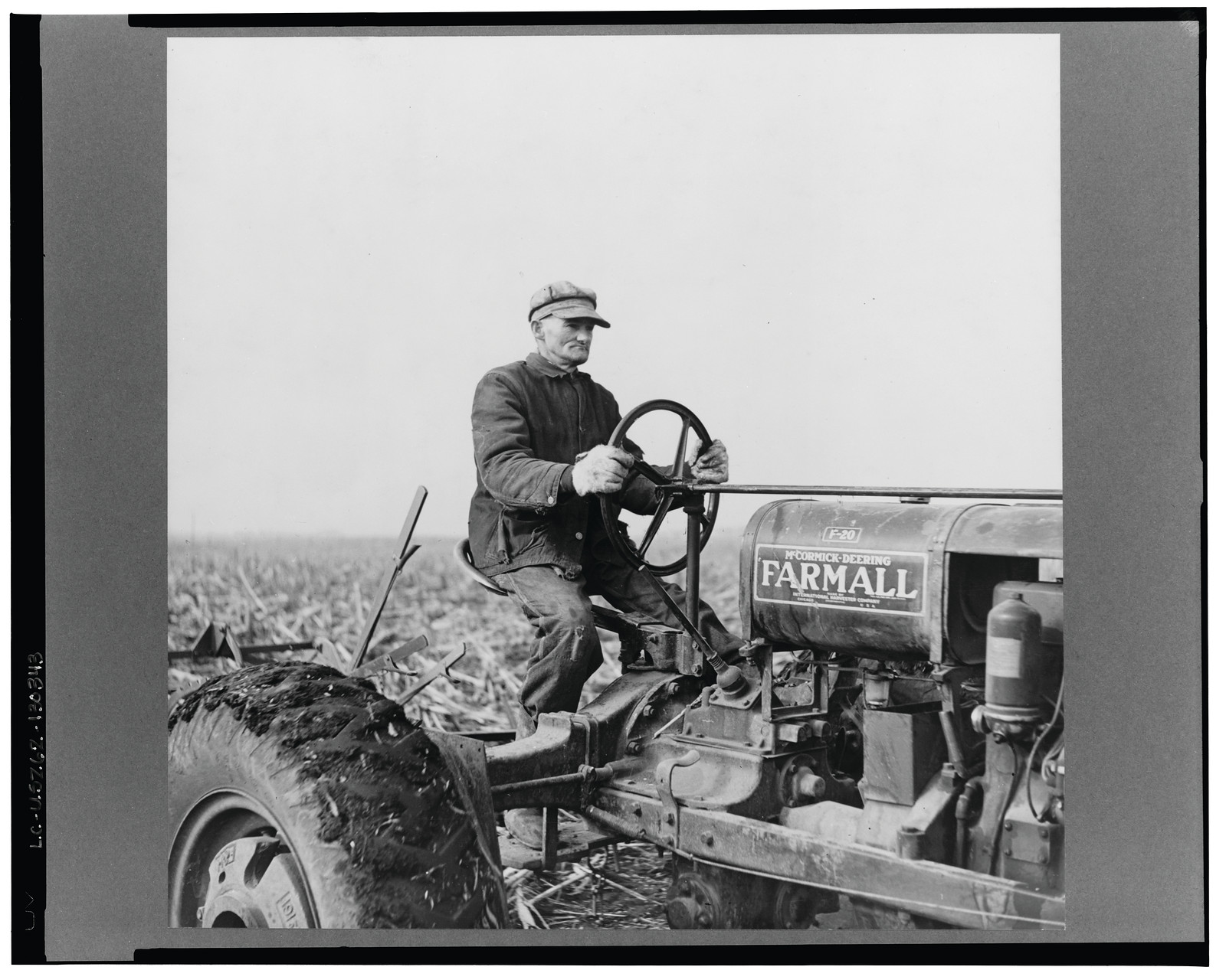 Tip Estes operating a tractor. Near Fowler, Indiana, 1937 Apr. — historic photograph