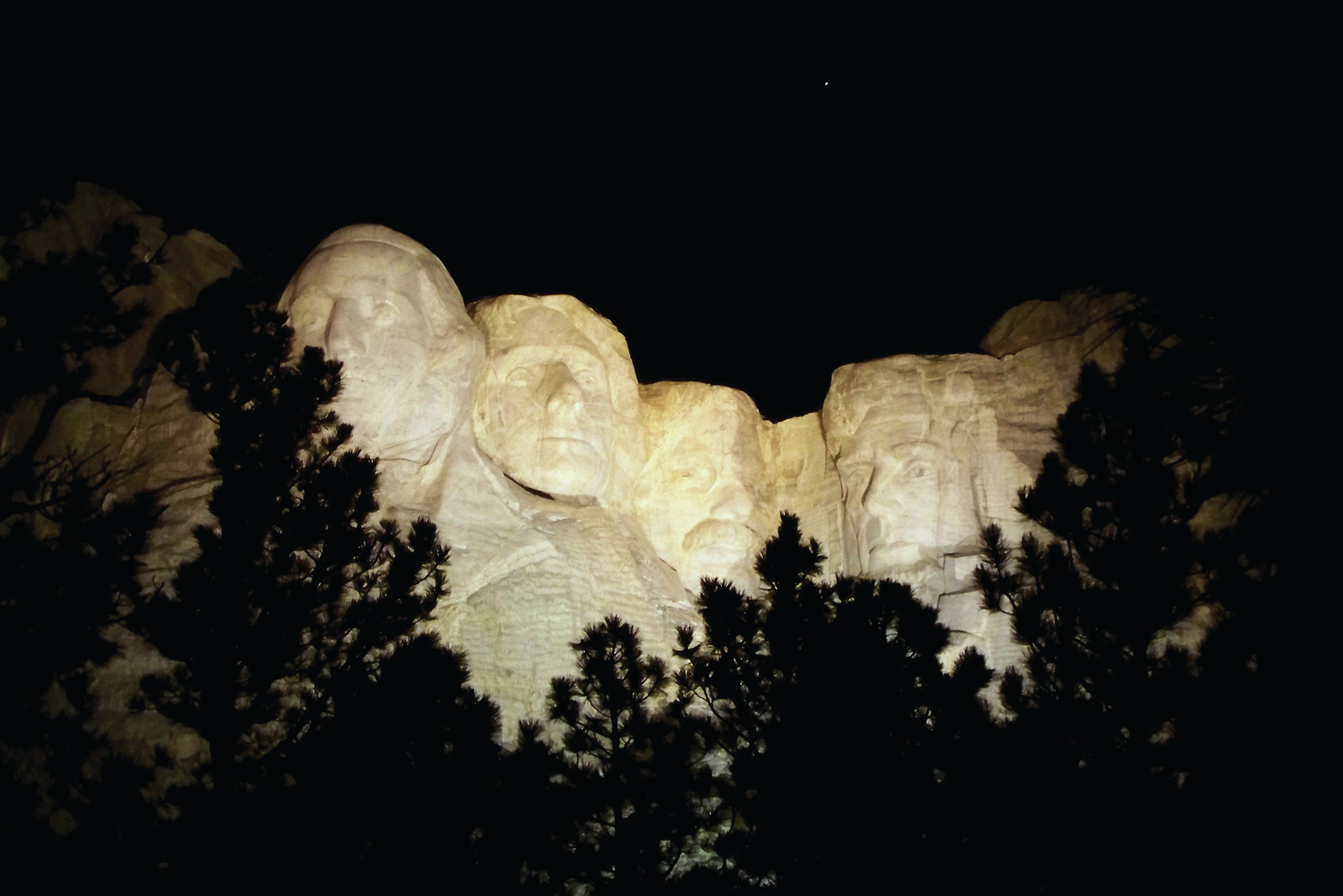 Mount Rushmore carved faces lit at night — historic image
