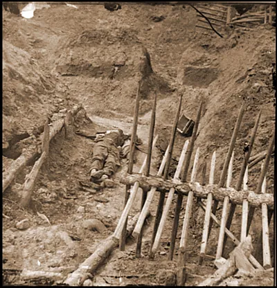 Petersburg Va. Dead Confederate soldier in trench beyond a section of chevaux-de-fr