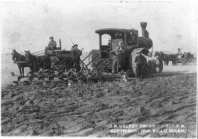 J.N. Welsby breaking sod, S.D.