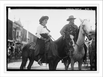 Cowgirl and cowboy on horseback, Newton, Kansas