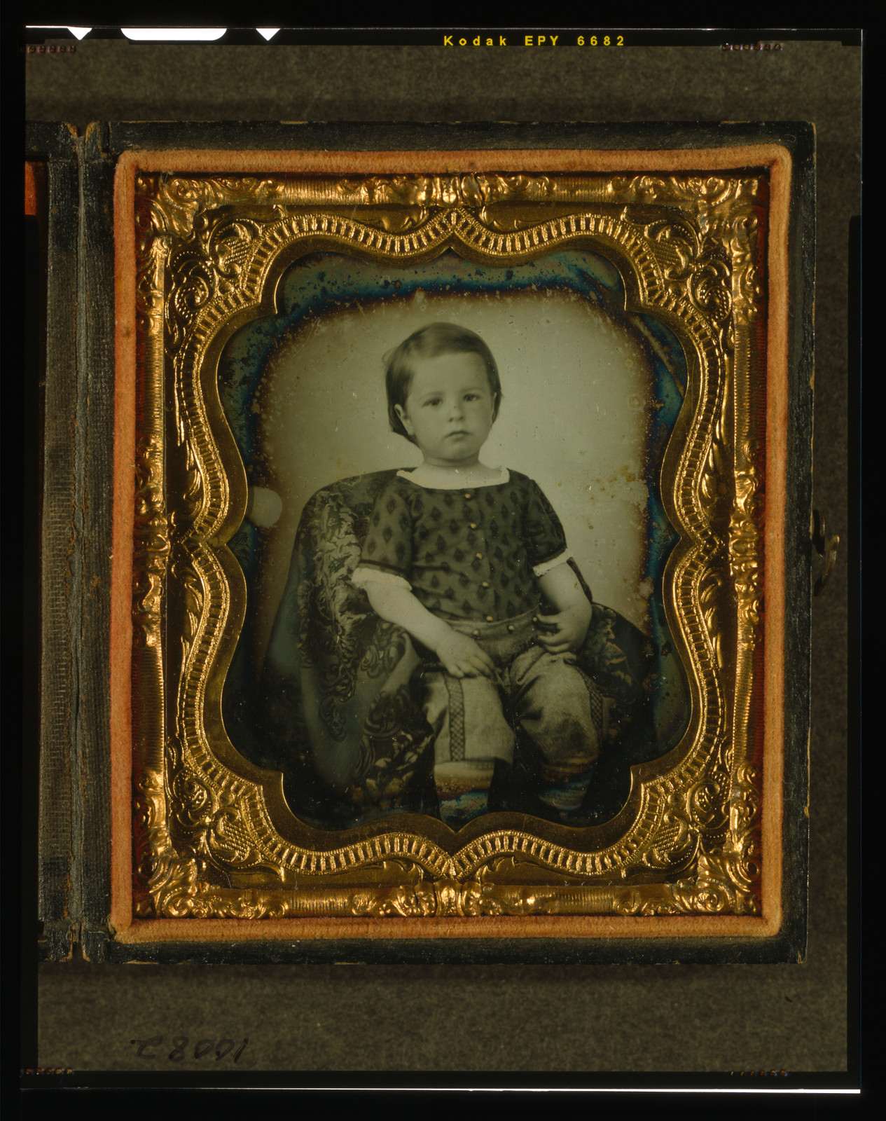 Seated young boy in gilt daguerreotype case, three-quarter view, 1840 — historic photograph