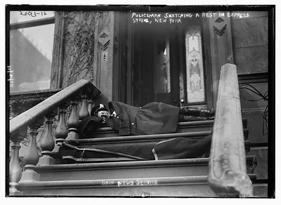 Policeman snatching a rest in express strike, New York