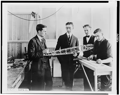 [Donald Douglas, Glenn Martin and other employees of the Glenn Martin Co., Cleveland, Ohio, looking at model airplane]
