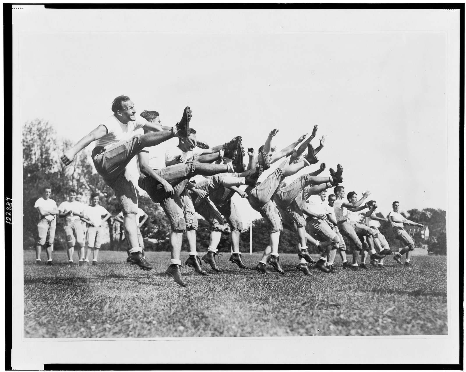 [Members of the Boston College football squad out for their first practice session of the season on the school's field] / photo by Underwood and Underwood., [between 1900 and 1940] — historic photograph