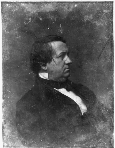 Profile portrait of a man in dark coat and cravat