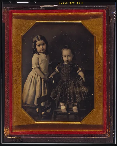 [Elisa and John McAllister, children of W.Y. McAllister, Elisa standing on chair, John sitting in high chair]