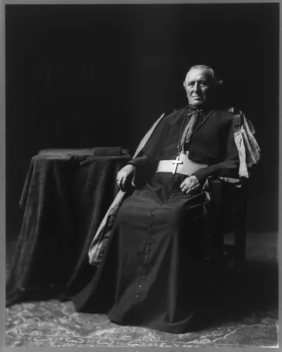 [Archbishop John Ireland, 1838-1918, full-length portrait, seated, facing left]