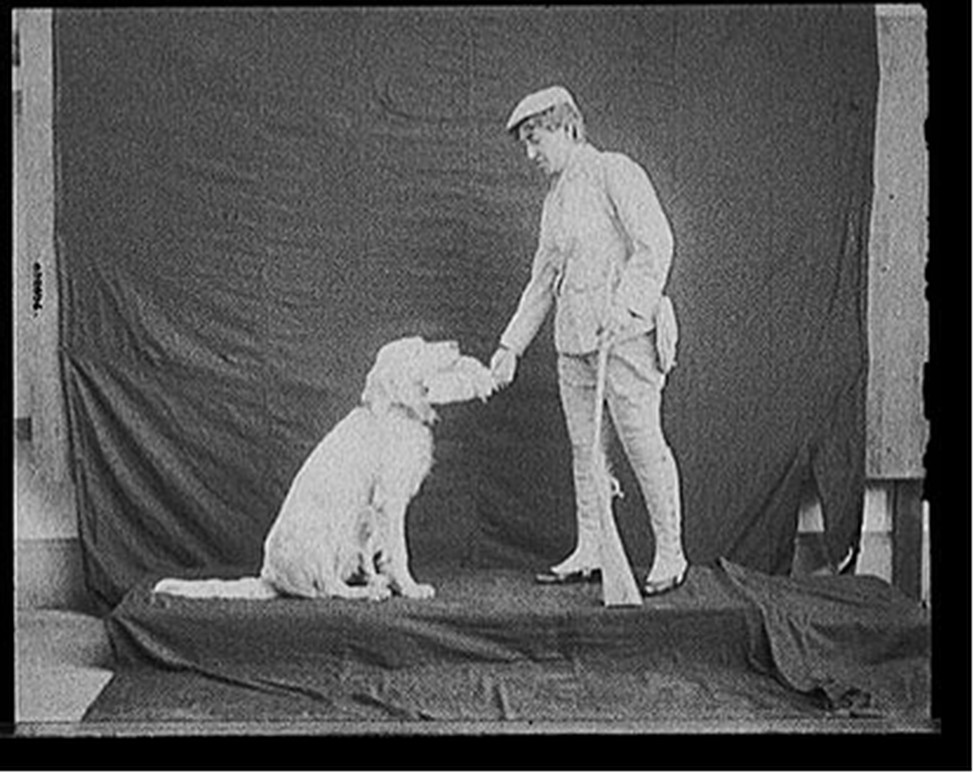 [Billy and his mistress in hunting poses], [between 1895 and 1910] — historic photograph