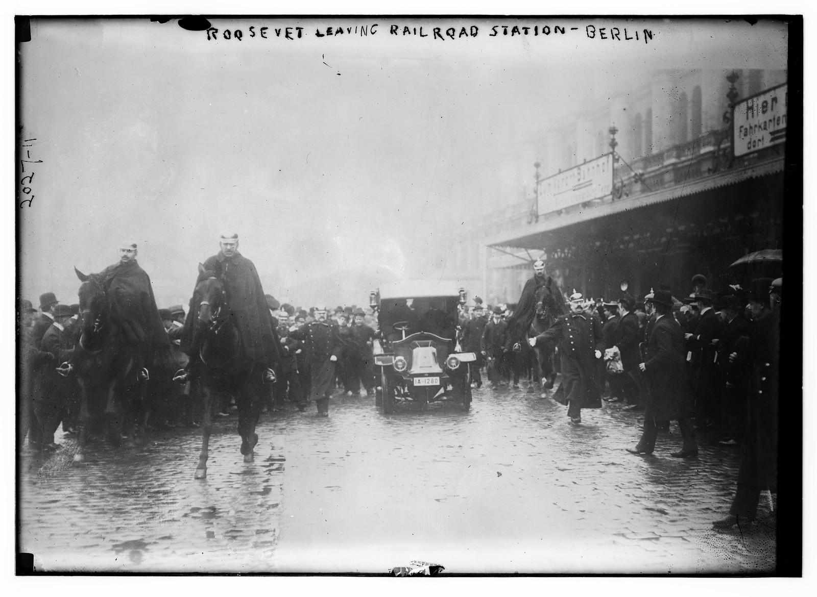 Roosevelt leaving railroad station Berlin. Crowd, car, and men on horseback., n/a — historic photograph