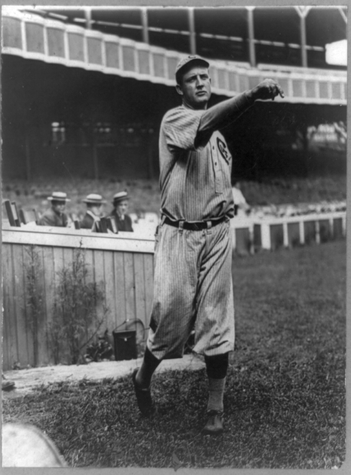 [Orval Overall, baseball player for Chicago Cubs, throwing baseball in front of grandstand], [1910 Aug. 25] — historic photograph