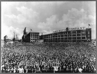 Michigan. Detroit. Several thousand employees massed before Ford Motor Company building