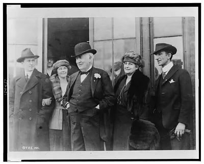 [Thomas Alva Edison, three-quarter length portrait, standing, facing left, with family group]