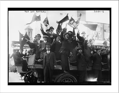Red Sox rooters waving flags on an open automobile