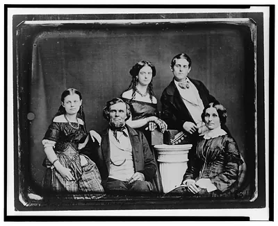 [Benjamin family group portrait, posed around a column]