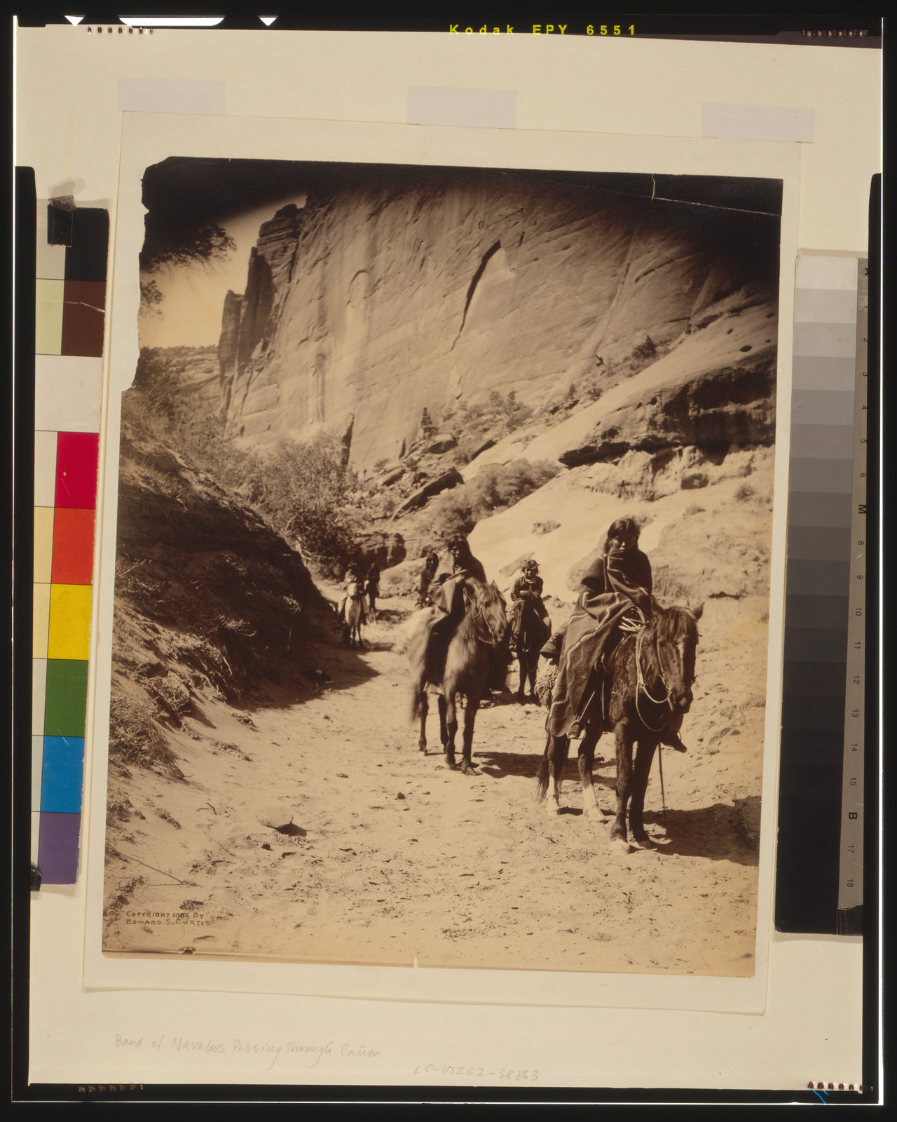 Band of mounted Navahos passing through Cañon, c1904. — historic photograph