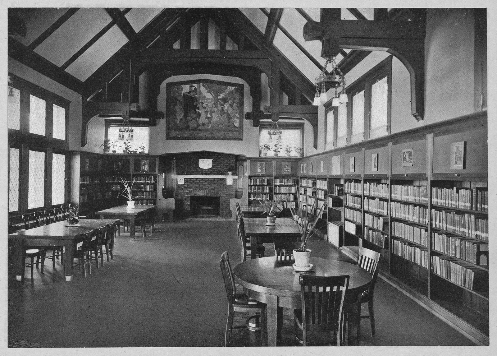 Library reading room with bookshelves and fireplace — historic image