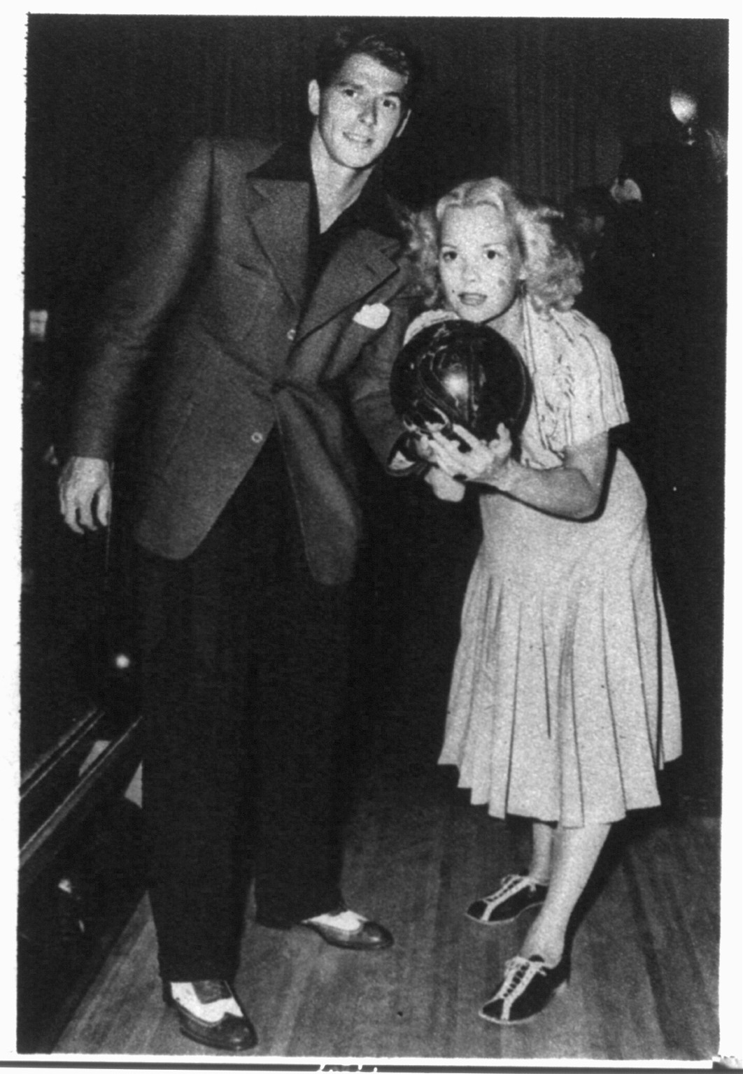 [Ronald Reagan with Jane Wyman holding bowling ball on bowling alley; scene from Brother Rat], 1943 March. — historic print
