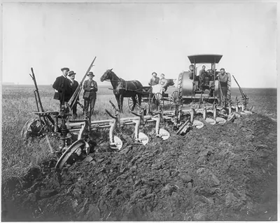 Plowing with gasoline tractor pulling 12-16 inch plows on John B. Siemer Farm, Harmony Township, Casselton, N.D.