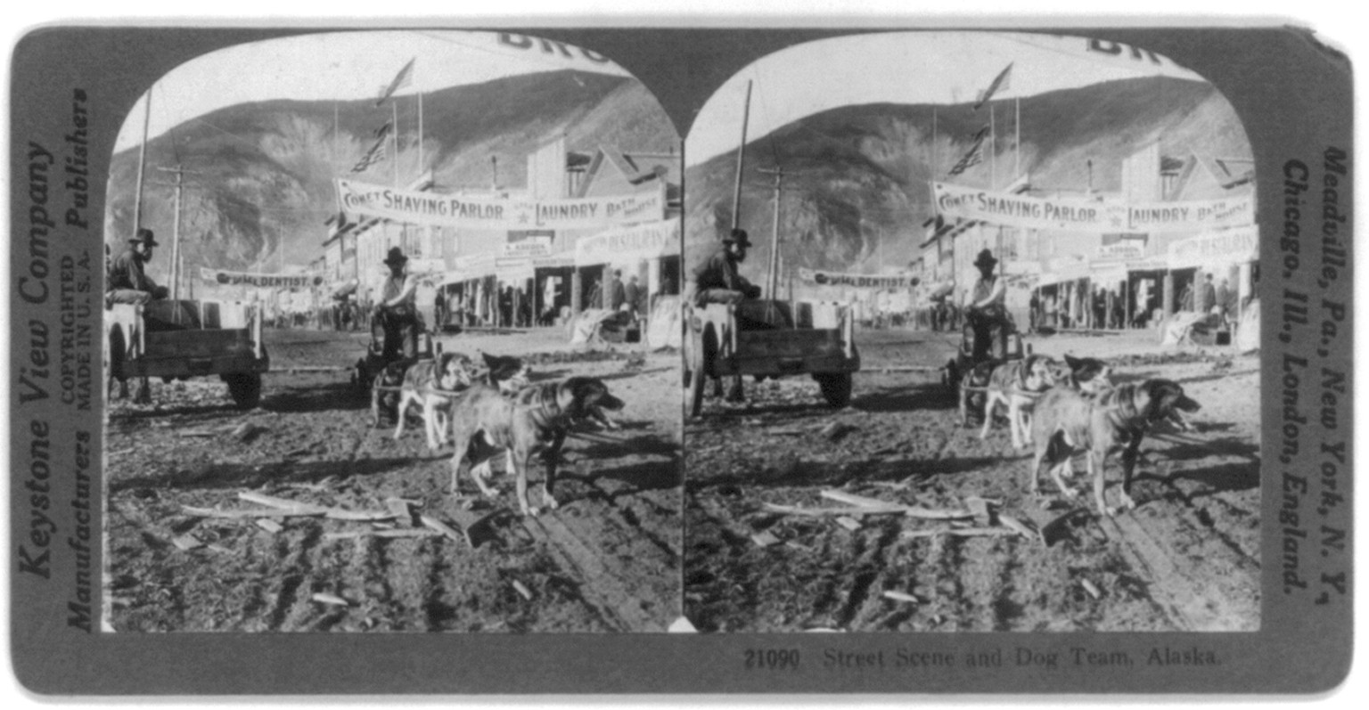 Street scene and dog team, Alaska, c1926. — historic photograph