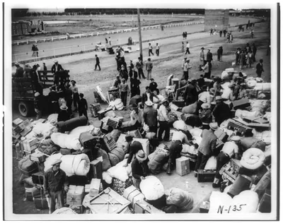 Tanforan (Calif.) Assembly Center - group of San Francisco evacuees arrive at center, May 11, 1942, and sort their luggage