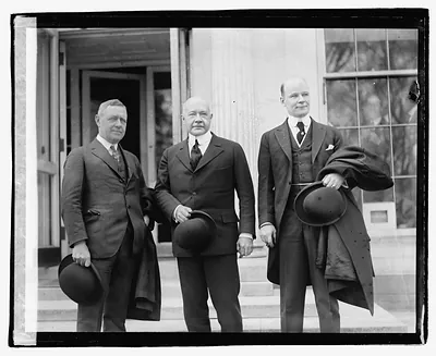 [Three men standing on steps outside building], 3/29/21