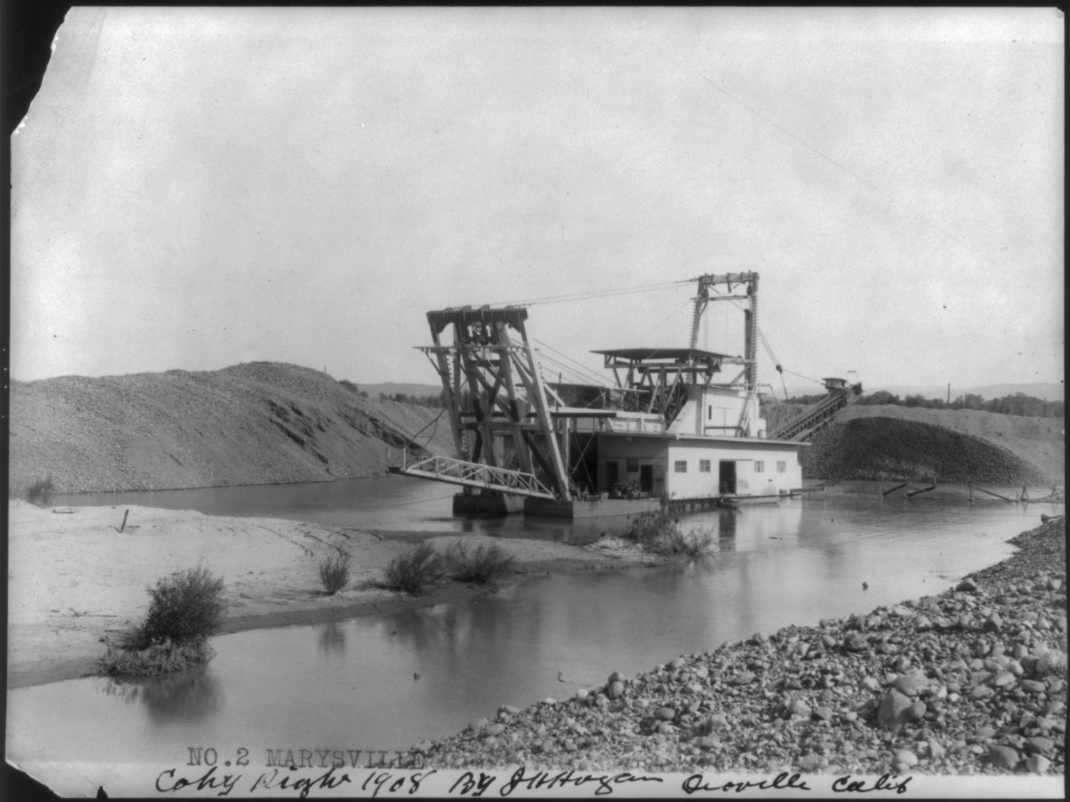 [Large dredge being used in gold-dredging operation on Yuba River (?) near Marysville, Calif.], c1908. — historic photograph