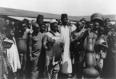 [Large group of people gathered around some men with musical instruments, Mombasa, Kenya]