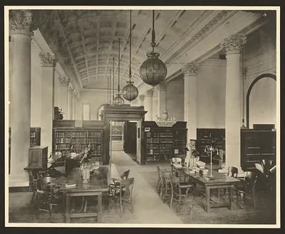Reading room with columns, pendant lamps and bookshelves