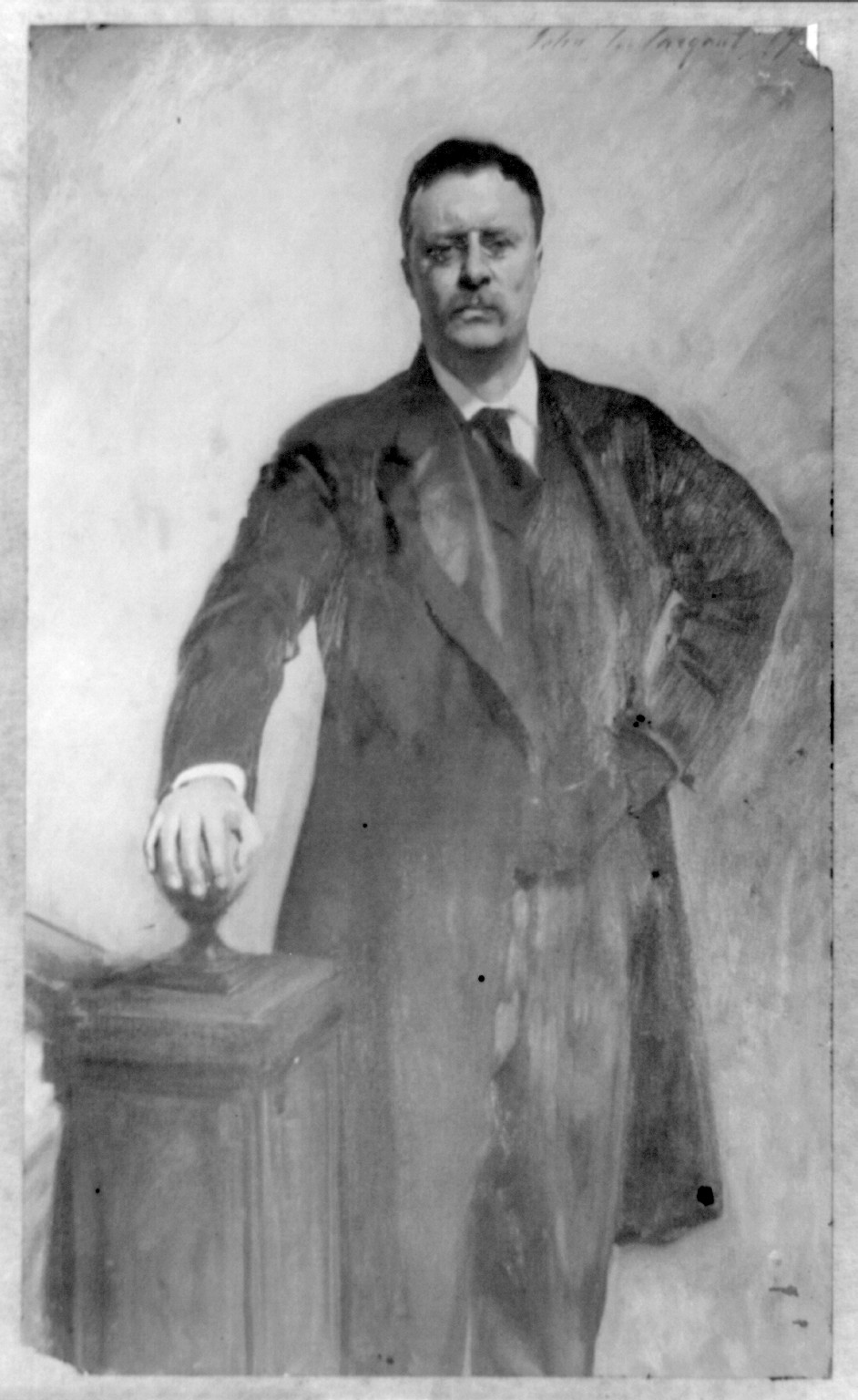 [Theodore Roosevelt, three-quarter length portrait, standing, facing front, right hand on stairway post], c1903. — historic photograph