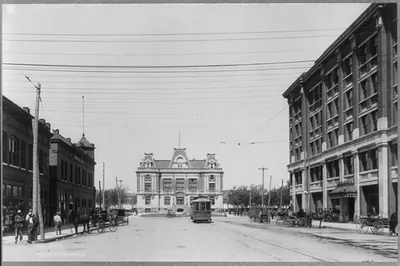 Broadway showing Garfield County Court House, [Enid, Okla,; facade, viewed down commercial street]