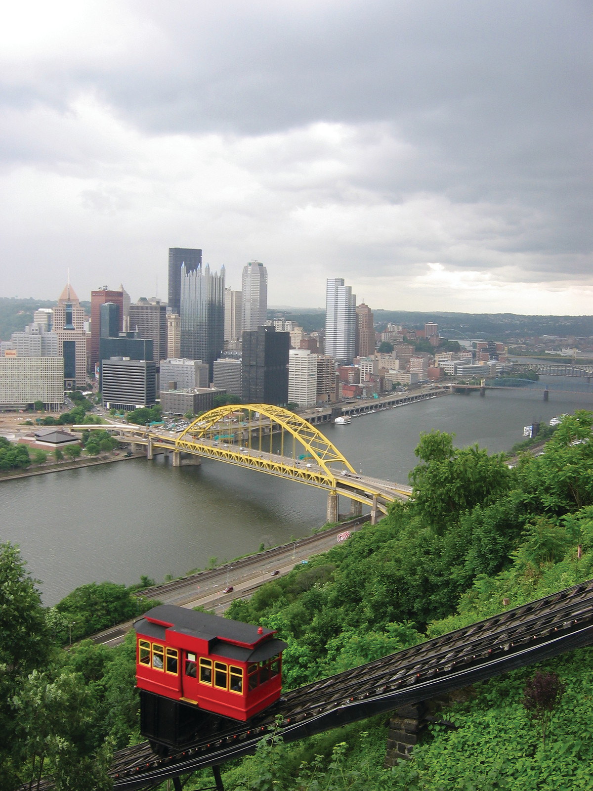 Red Duquesne Incline car overlooking downtown Pittsburgh skyline — historic image