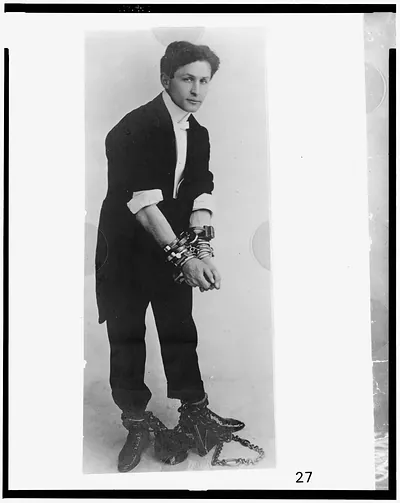 [Harry Houdini, full-length portrait, standing, facing right, in chains]