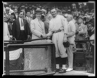 [President Coolidge shaking hands with Walter Johnson at Griffith Stadium]