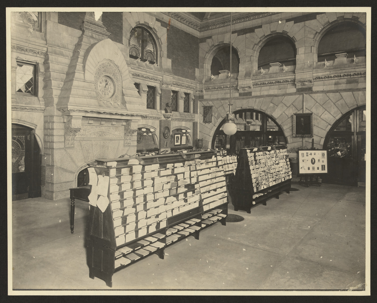 Stone-arched interior with book display racks — historic image