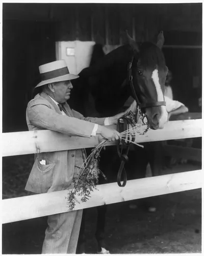 Unbeaten three-year-old Gallant Fox, dean of racing horses, cynosure of all eyes at Saratoga track. Saratoga Springs, N.Y. Trainer Sunny Jim Fitzsimmons with Gallant Fox
