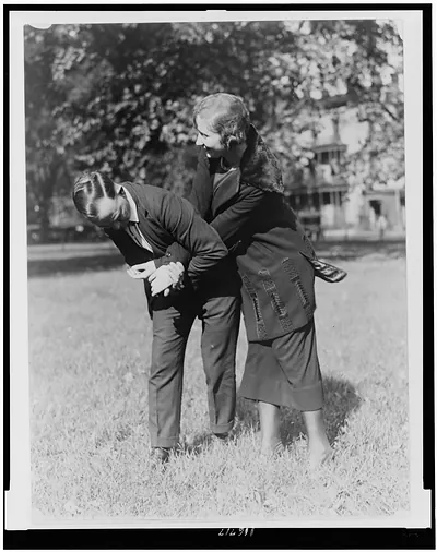 [Policewoman and policeman practicing self-defense]
