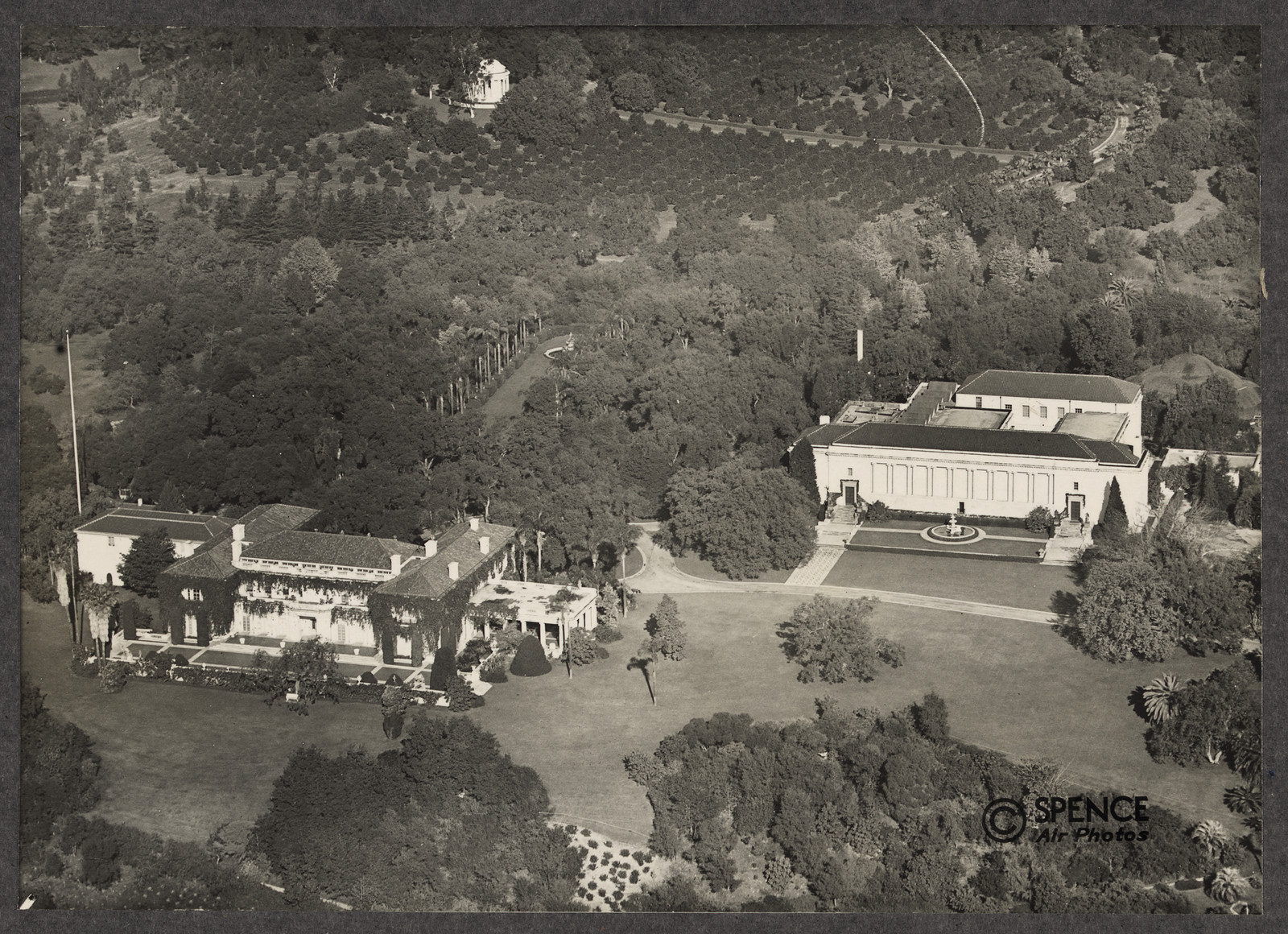 Aerial view of a mansion, classical gallery and gardens — historic image