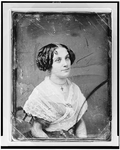 Portrait of a woman with lace shawl and cross necklace
