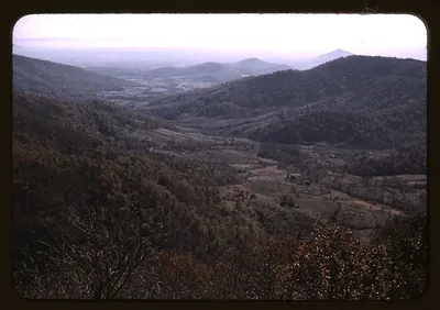 Forested mountain valley with farmland seen from an overlook