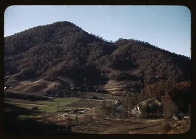Forested mountain above a valley of farm fields