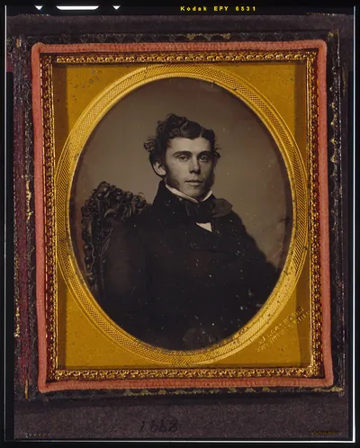 [Unidentified man, head-and-shoulders portrait, facing right, seated in chair]